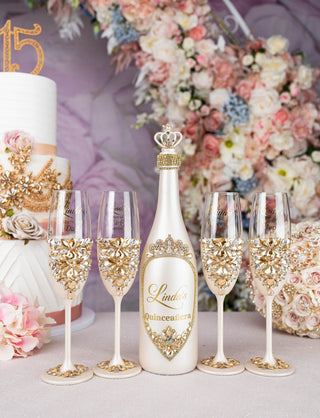 Gold quinceanera brindis package with bottle and candle